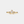Gold ring with three diamond stones on a light gray background