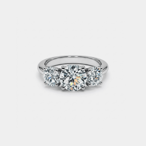 Three-stone diamond ring on a light gray background