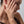Woman with hand on face against a neutral background