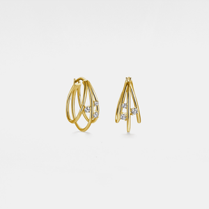 Gold hoop earrings with small diamonds on a light gray background
