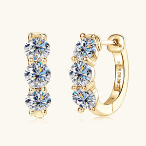 Gold hoop earrings with clear gemstones on a white background