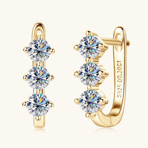 Gold hoop earrings with clear gemstones on a white background