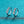 Pair of silver earrings with clear gemstones on a teal background