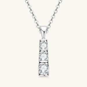Diamond necklace with three round-cut diamonds on a white background