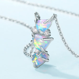 Opal necklace with triangular stones on a light blue background