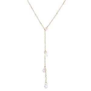 Gold necklace with pearls on a white background