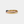 Three gold rings of different colors on a light gray background