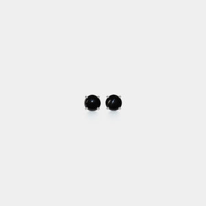 Pair of black stud earrings on a white background