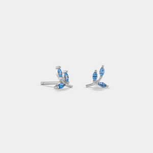 A pair of gold-plated sterling silver leaf stud earrings with blue cubic zirconia stones.