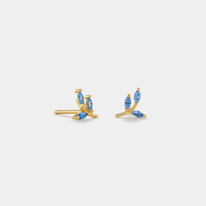 Gold earrings with blue gemstones on a white background