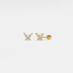 Gold butterfly earrings on a light gray background
