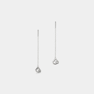 Silver heart-shaped earrings on a light gray background