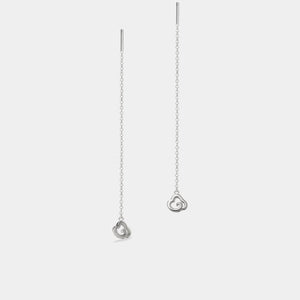 Silver necklace with heart-shaped pendants on a light gray background