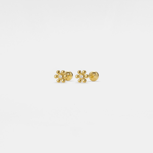 Gold flower-shaped earrings with clear gemstones on a white background