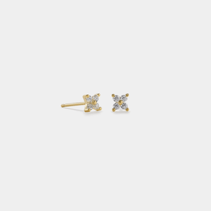 A pair of gold-plated sterling silver stud earrings featuring a four-petal flower design with cubic zirconia in the center.