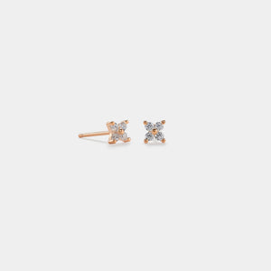 Pair of diamond stud earrings on a light gray background