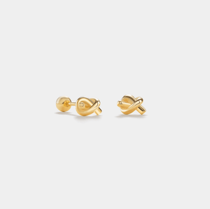 Pair of gold earrings on a light gray background