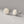 Pair of silver floral earrings on a gray background