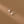 Pair of pearl stud earrings on a brown background