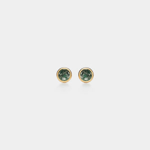 Pair of round green gemstone earrings on a white background