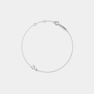 A delicate gold-plated sterling silver bracelet featuring a small opal charm and a tulip design, with an adjustable chain.