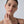 Woman touching her neck with a plain background