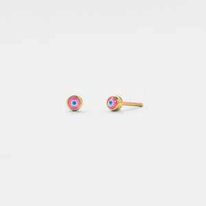 Gold earrings with colorful gemstones on a light gray background