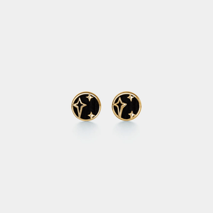 Pair of round earrings with star design on a light gray background