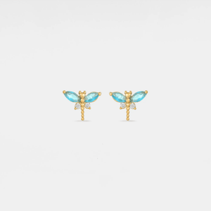 Gold earrings with turquoise gemstones on a light gray background