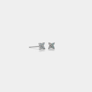 Pair of silver butterfly earrings on a light gray background