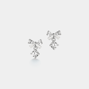 A pair of small bow dangle drop earrings made with 925 sterling silver and cubic zirconia, featuring a gold plating.