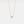 A small bow-shaped pendant necklace with a gold plating on a silver chain, presented against a white background.