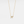 Gold necklace with a bow pendant on a light gray background