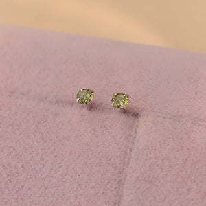 A collection of small, solid 925 sterling silver stud earrings with various colors of cubic zirconia displayed on a light background.