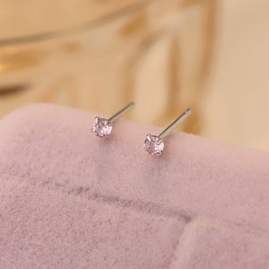 A collection of small, solid 925 sterling silver stud earrings with various colors of cubic zirconia displayed on a light background.