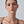 Close-up of a woman's neck and shoulders against a plain background