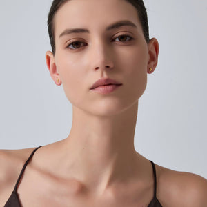 Close-up of a woman's neck and shoulders against a plain background