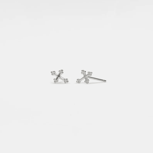 A pair of small gold-plated stud earrings designed in the shape of a cross.