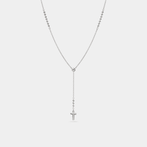 Silver necklace with a cross pendant on a light gray background