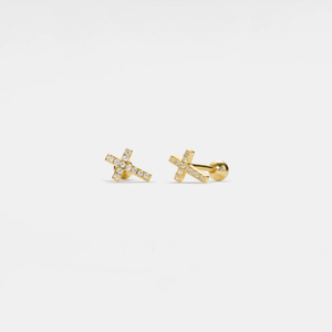 Gold earrings with small diamonds on a light gray background