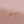 Gold earrings with circular design on a pink background