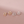 Pair of gold and silver circular earrings on a pink background