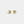 Gold four-leaf clover earrings with green gemstones on a light gray background