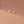 Gold earrings on a brown background