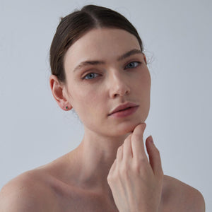 Woman with a neutral expression against a plain background