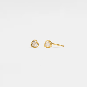 Heart-shaped gold earrings on a light gray background