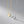 Two heart-shaped pendants on gold and silver chains against a gray background