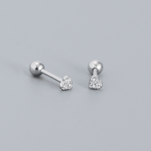 Pair of silver heart-shaped stud earrings on a gray background