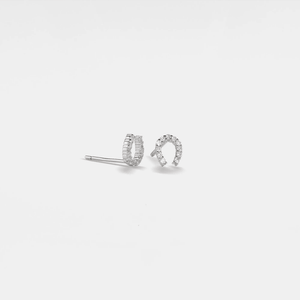A pair of small horseshoe stud earrings made of solid 925 sterling silver with cubic zirconia, featuring a gold plating finish.