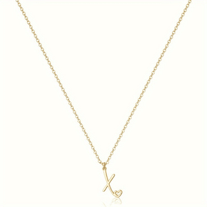 Gold necklace with a heart-shaped pendant on a white background